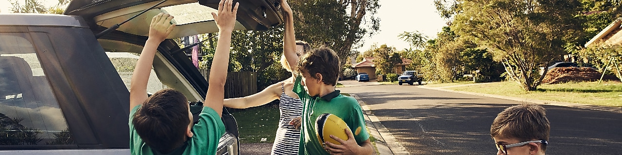 Arriving home after school! Shot of a woman arriving at home with her sons after picking them up at school