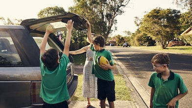 Arriving home after school! Shot of a woman arriving at home with her sons after picking them up at school
