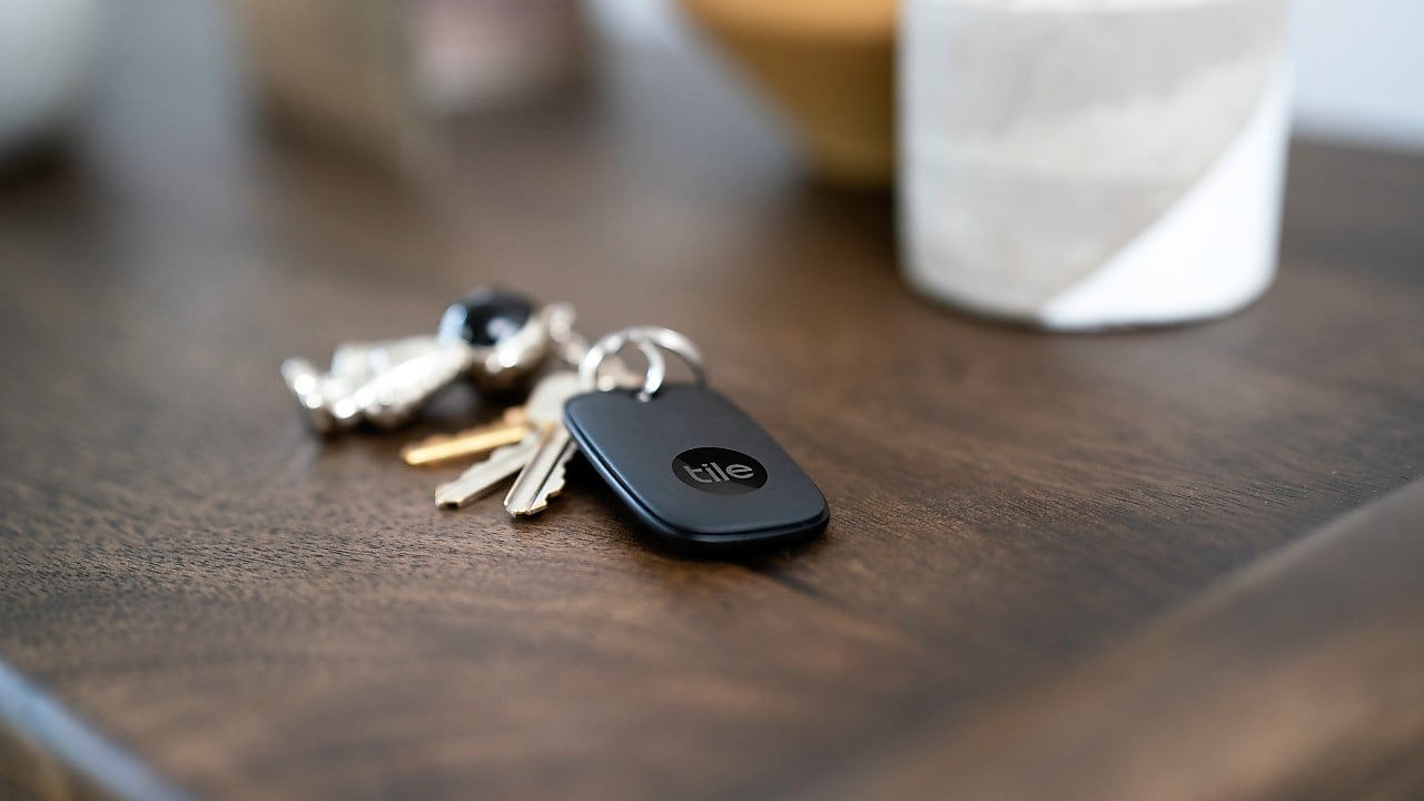 Set of keys on a table with a Tile Bluetooth tracker