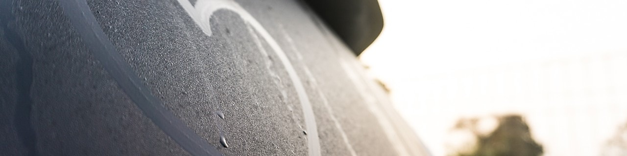 A close-up view of a heart drawn into the condensation on a car’s rear windscreen.