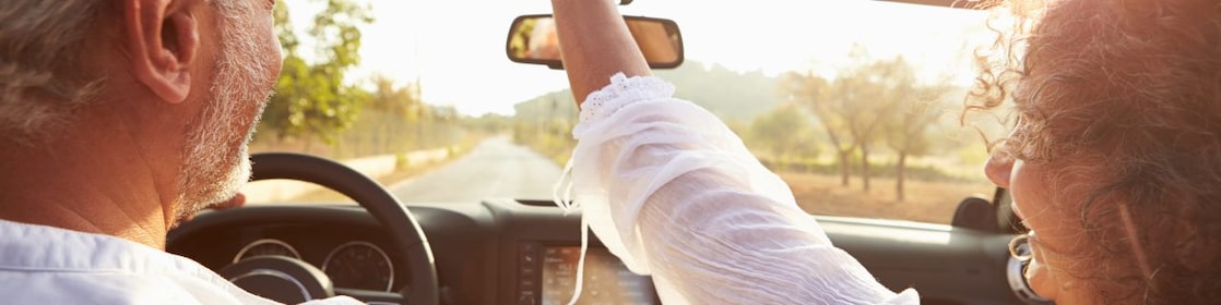 Man and woman driving in a convertible