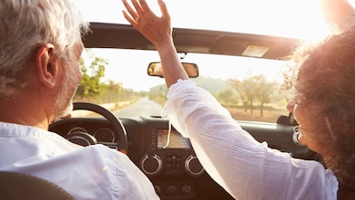 Man and woman driving in a convertible