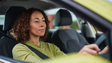 Woman driving with hands on steering wheel