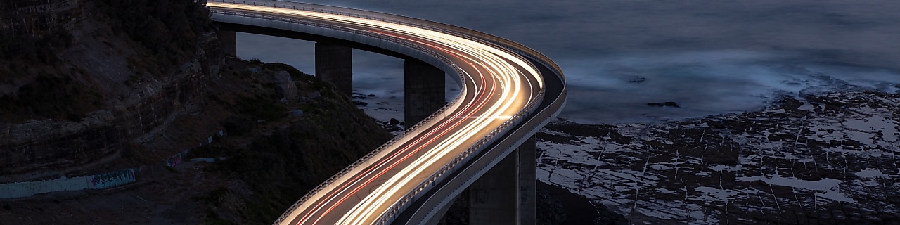 Car light trails on Sea Cliff Bridge, a balanced cantilever bridge located south of Sydney, New South Wales, Australia