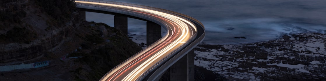 Car light trails on Sea Cliff Bridge, a balanced cantilever bridge located south of Sydney, New South Wales, Australia