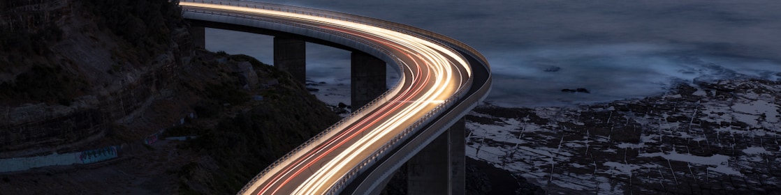 Car light trails on Sea Cliff Bridge, a balanced cantilever bridge located south of Sydney, New South Wales, Australia