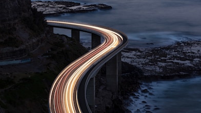 Car light trails on Sea Cliff Bridge, a balanced cantilever bridge located south of Sydney, New South Wales, Australia