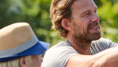 father and son organising the roof racks of their car