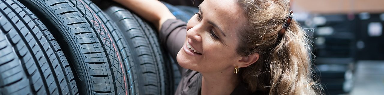 Woman inspecting tyres