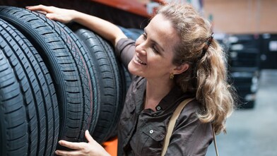 Woman inspecting tyres