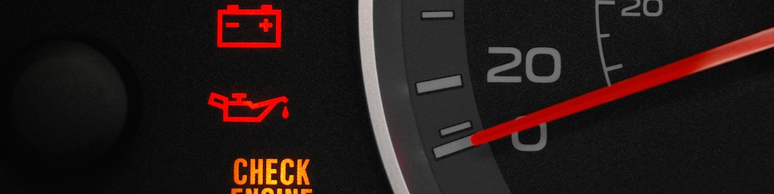 A detailed view of a car dashboard featuring a glowing check engine light, signaling the need for vehicle maintenance.