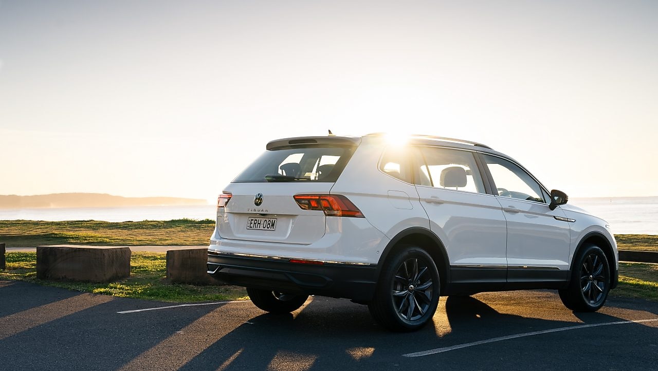 A white Volkswagen Tiguan Allspace parked in a waterfront carpark