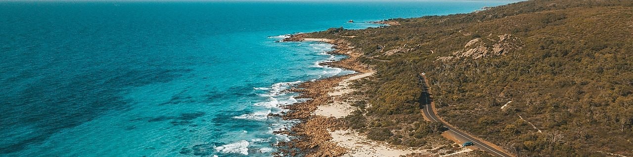 An aerial view of the road that follows the coastline in Eagle Bay, Western Australia.
