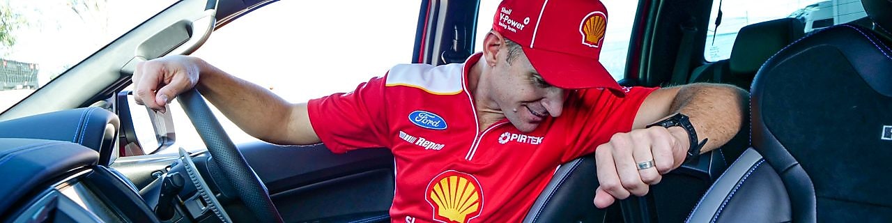 Will Davison looking in his car glovebox