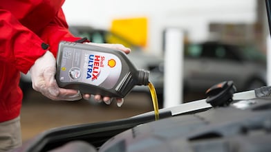 Shell Helix Ultra being poured into an engine