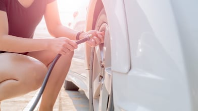 Woman filling up their tyre with air