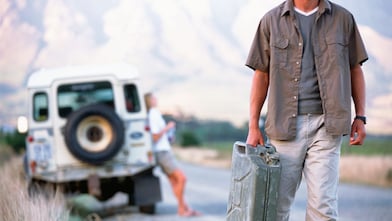 Man walking down the road with a jerry can