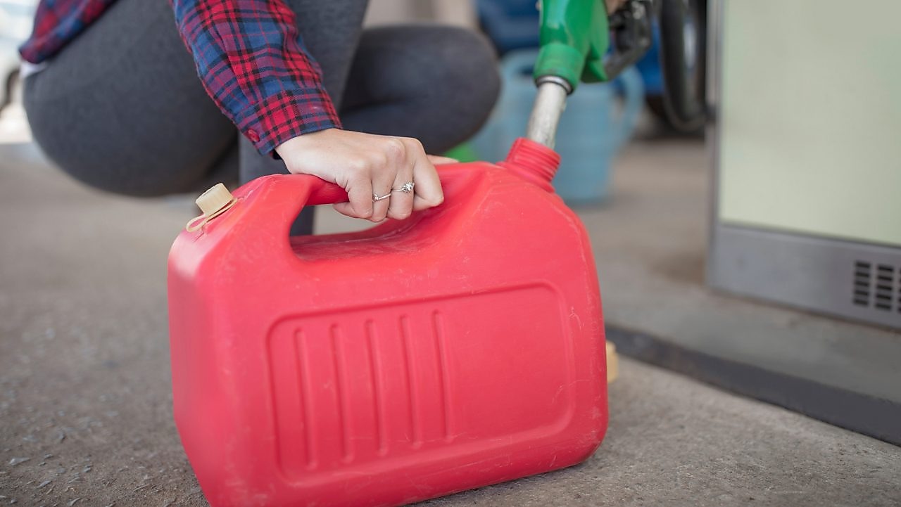 Person filling up a portable fuel container