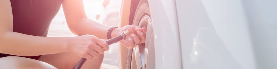 Woman filling up their tyre with air