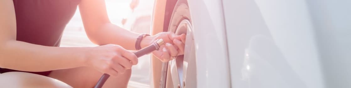 Woman filling up their tyre with air