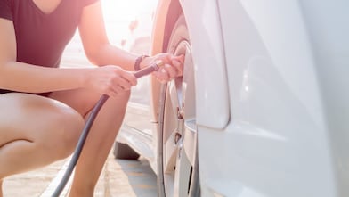 Woman filling up their tyre with air