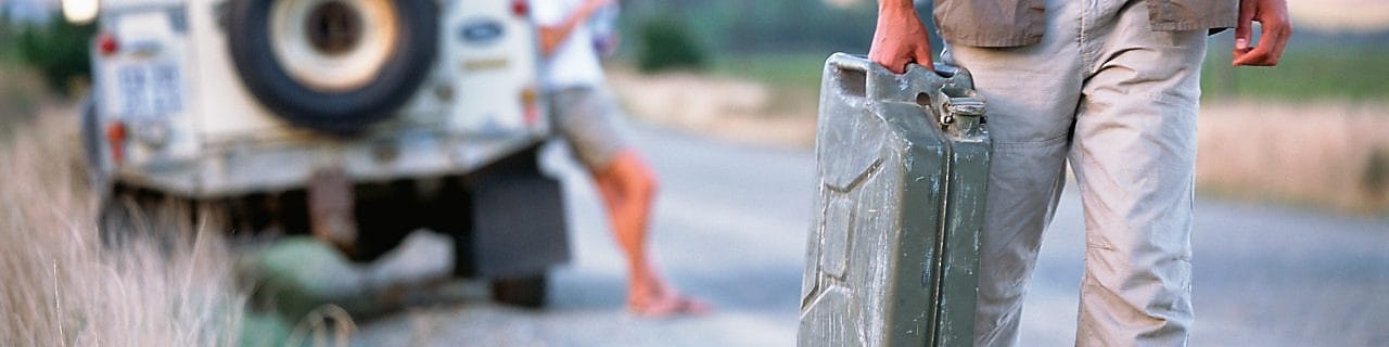 Man walking down the road with a jerry can