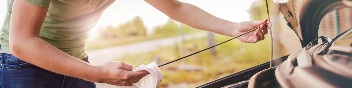 Man checking oil in car