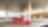 A red Ferrari sitting on a Shell station forecourt with a man leaning on a petrol pump