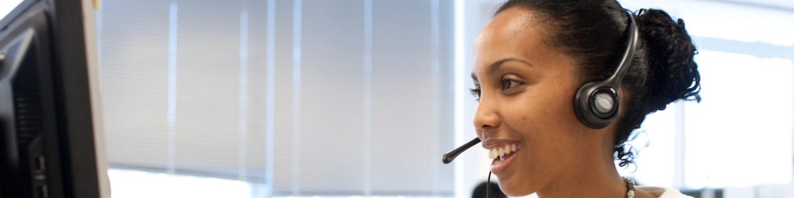 Woman in call centre facing her computer screen
