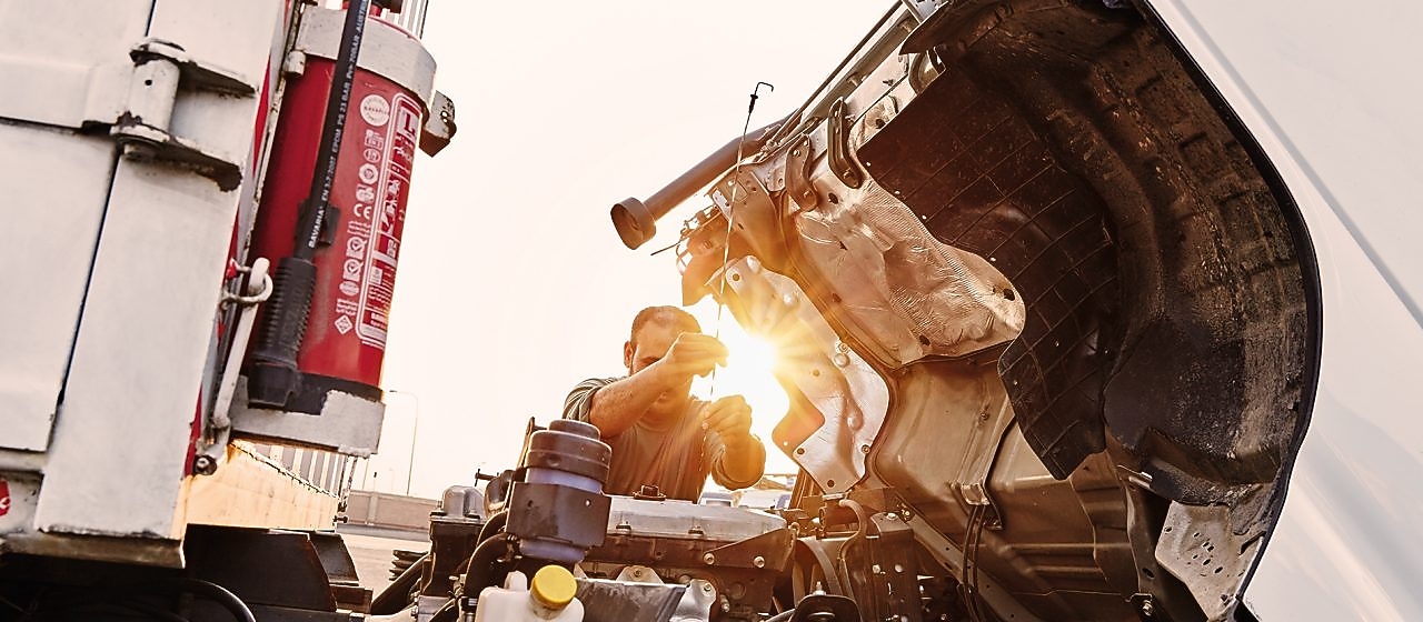 man checking truck engine