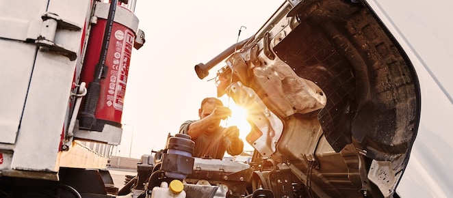man checking truck engine
