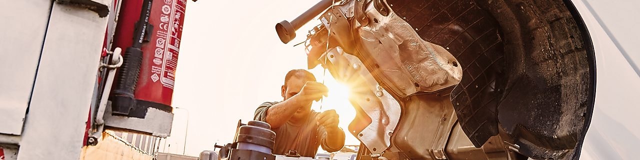 man checking truck engine