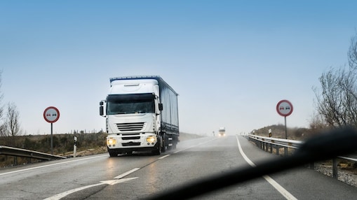 road with two heavy trucks coming