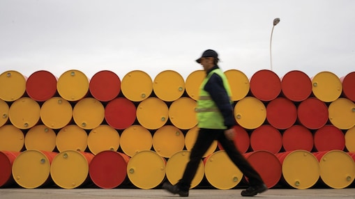 Man walking past barrels of Lubricants