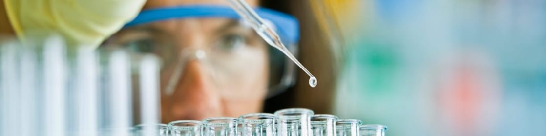 lab technician pipette liquid into test tubes