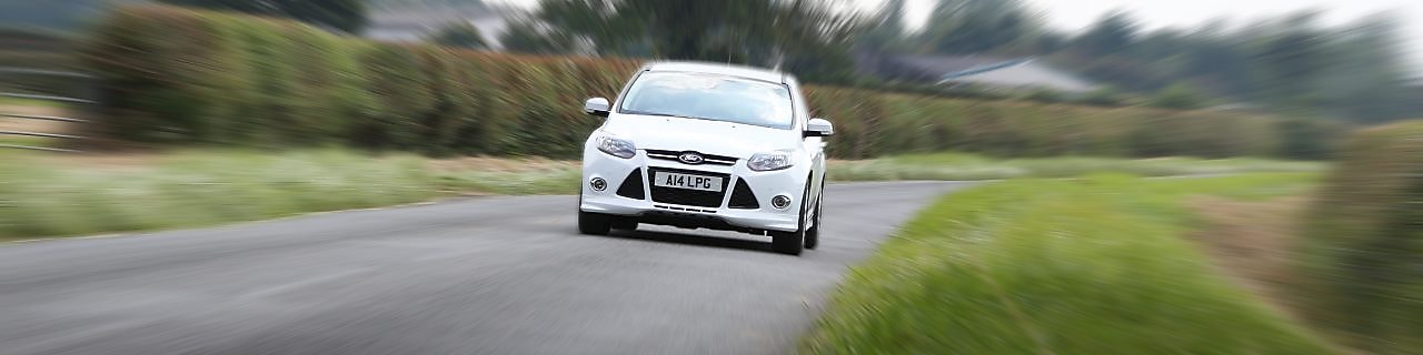White car driving on the country road