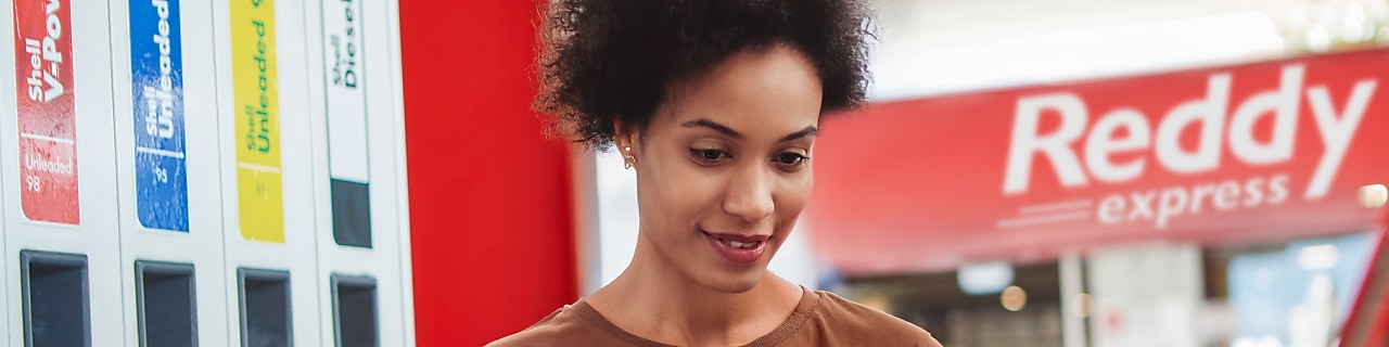 Woman filling fuel in car