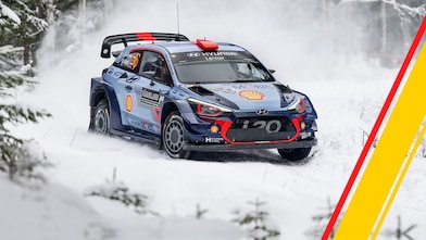 Hyundai World Rally Championship car racing on a snow-covered stage