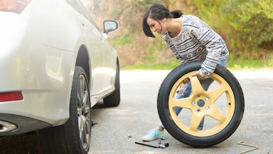 Woman changing a tyre