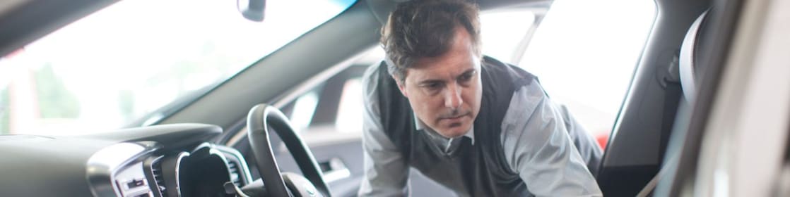 Man looking inside a car