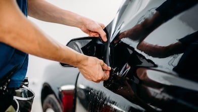 Car buyer reviewing dealer add-on options before signing