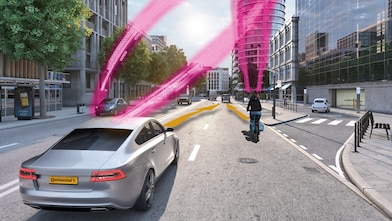 A car and a cyclist on a city road both receive a collision warning via advanced sensor tech