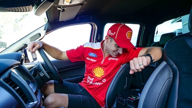 Will Davison looking in his car glovebox