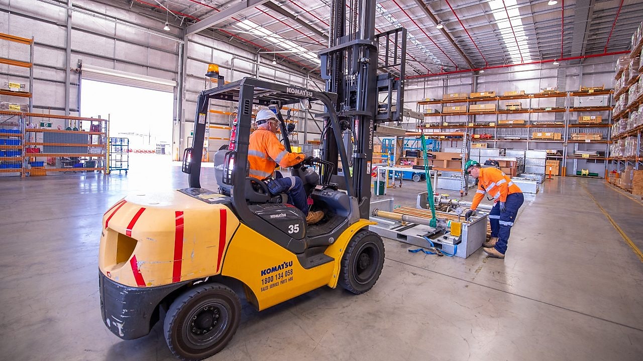 Forklift driving and moving stock in warehouse