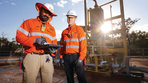 QGC wellsite operators check well performance.